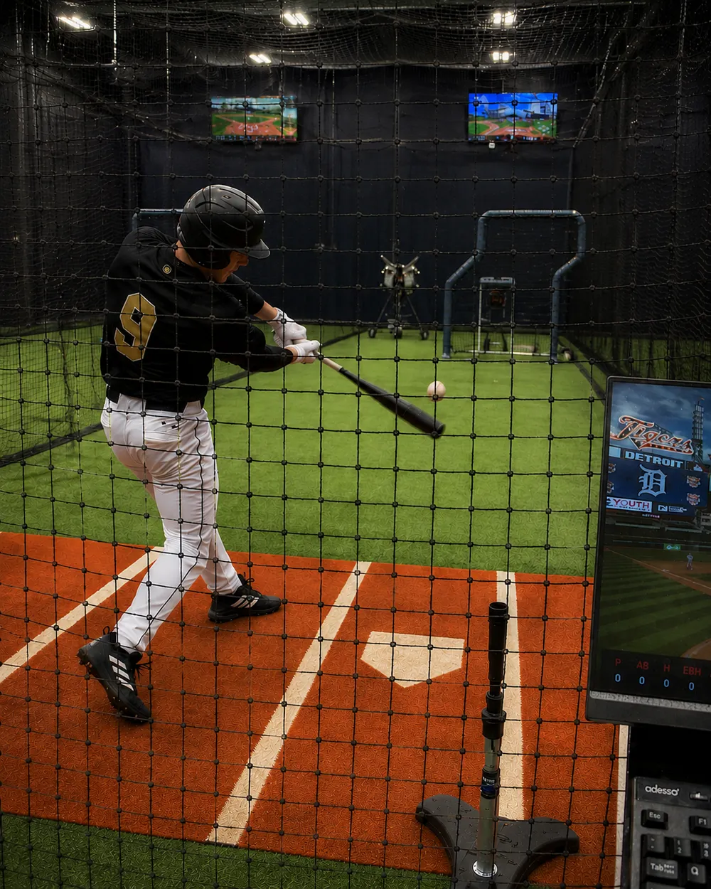 Hitter taking a swing in a cage at Inge Performance Lab